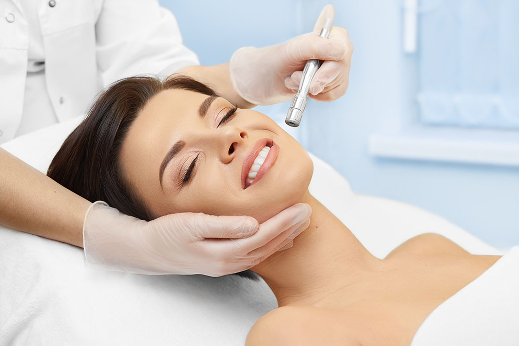 Hardware cosmetology. Spa clinic. Beautiful woman at skin treatment procedure. Microdermabrasion. Young healthy skin. Facial exfoliating. Skin rejuvenation. Beauty treatment. Cosmetology.