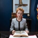 Photo by RDNE Stock project: https://www.pexels.com/photo/woman-in-white-and-black-long-sleeves-and-red-earrings-holding-an-open-book-6172543/