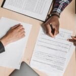 Photo by Pavel Danilyuk: https://www.pexels.com/photo/people-doing-paperwork-at-a-desk-8152735/